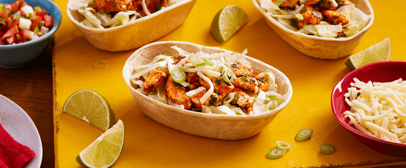 delicious dinner dish of coriander lime chicken tacos placed on yellow board